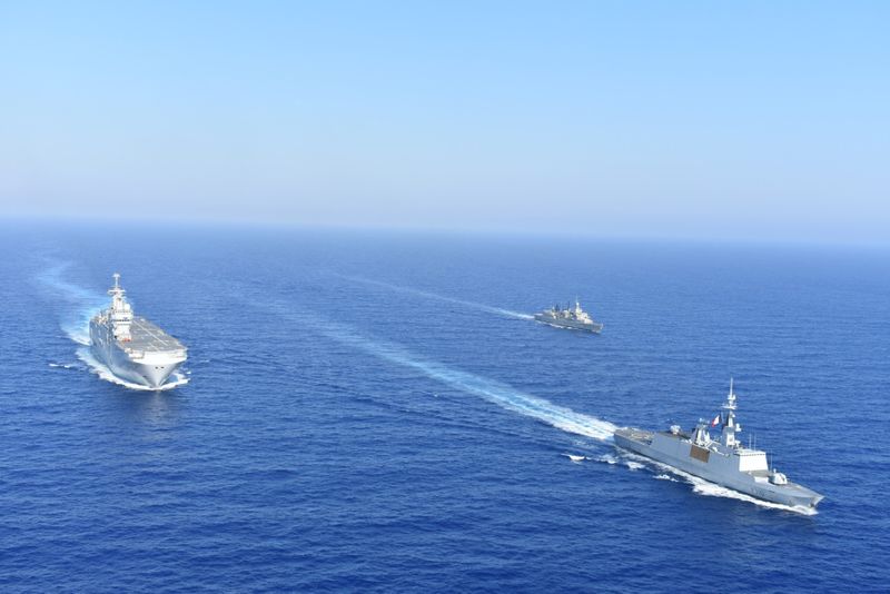 Greek and French vessels sail in formation during a joint