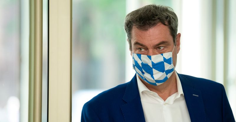 FILE PHOTO: Bavarian State Prime Minister Markus Soeder leaves a