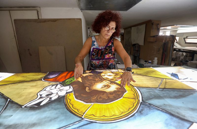 Stained glass maker Maya Husseini works inside her workshop in