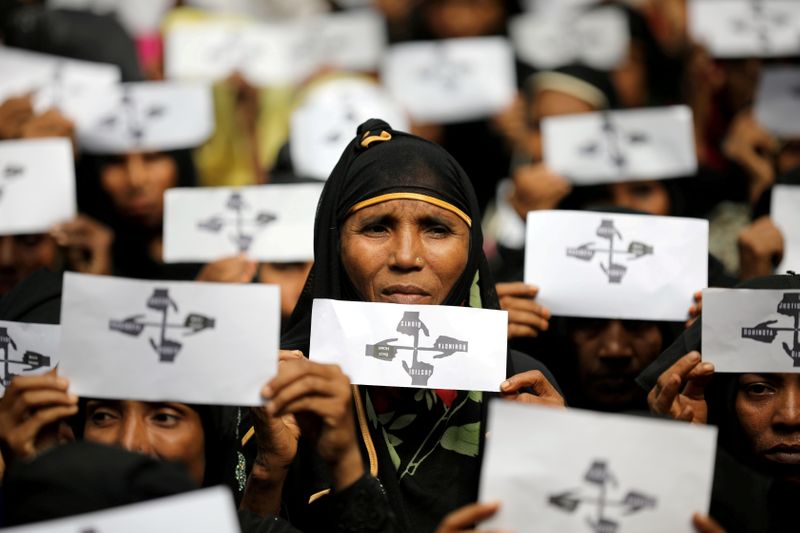 FILE PHOTO: Rohingya refugee women hold placards as they take