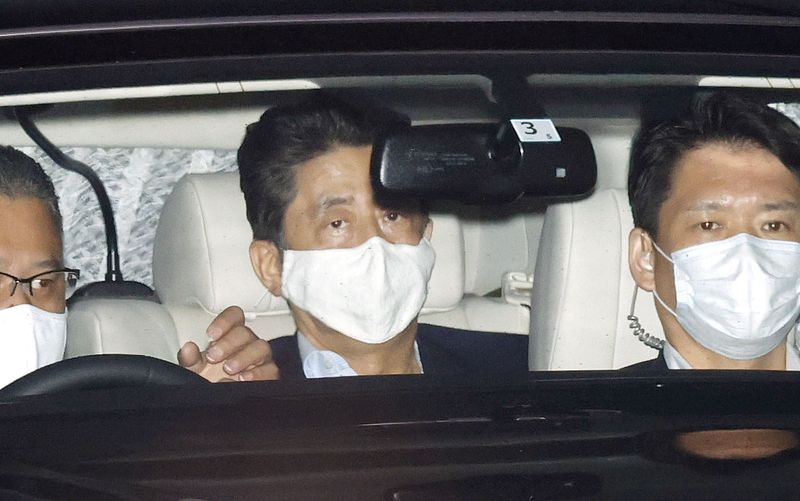 Japanese Prime Minister Shinzo Abe arrives at his residence as