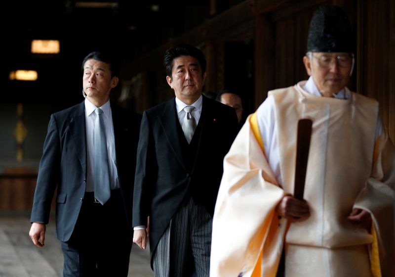 FILE PHOTO : Japan’s PM Abe is led by a