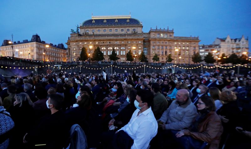 People watch a classical concert on a floating stage in