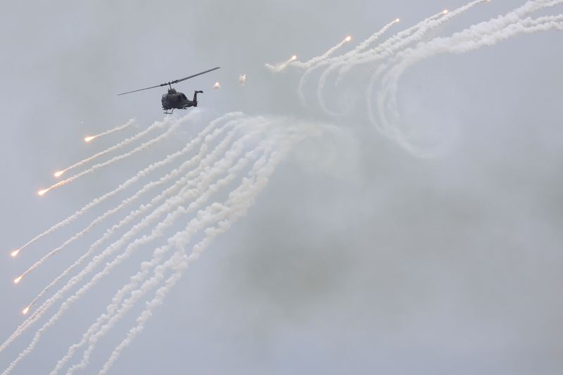 FILE PHOTO: An AH-1 Cobra helicopter fires during the live-fire,