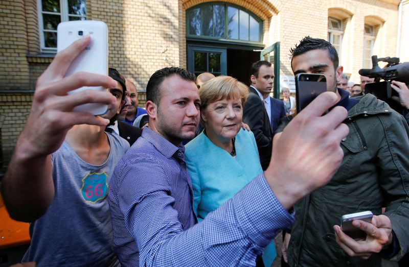 FILE PHOTO: Migrants from Syria and Iraq take selfies with