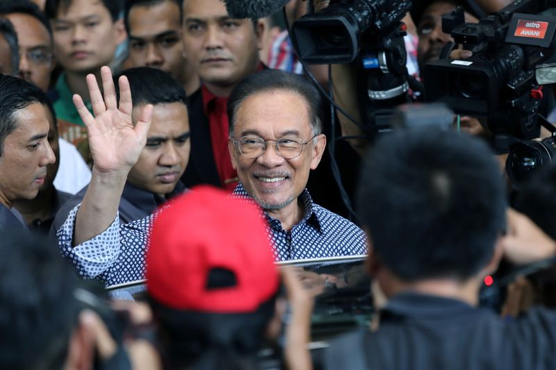 Malaysia’s politician Anwar Ibrahim leaves after a meeting in Petaling