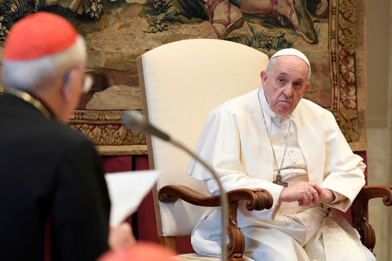 FILE PHOTO: Pope Francis listens during the traditional greetings to