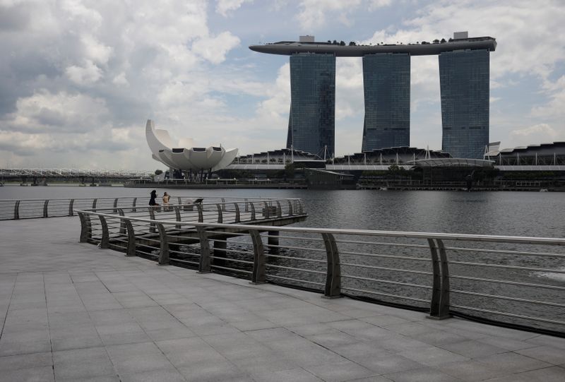 People take photos at an empty Merlion Park amid the