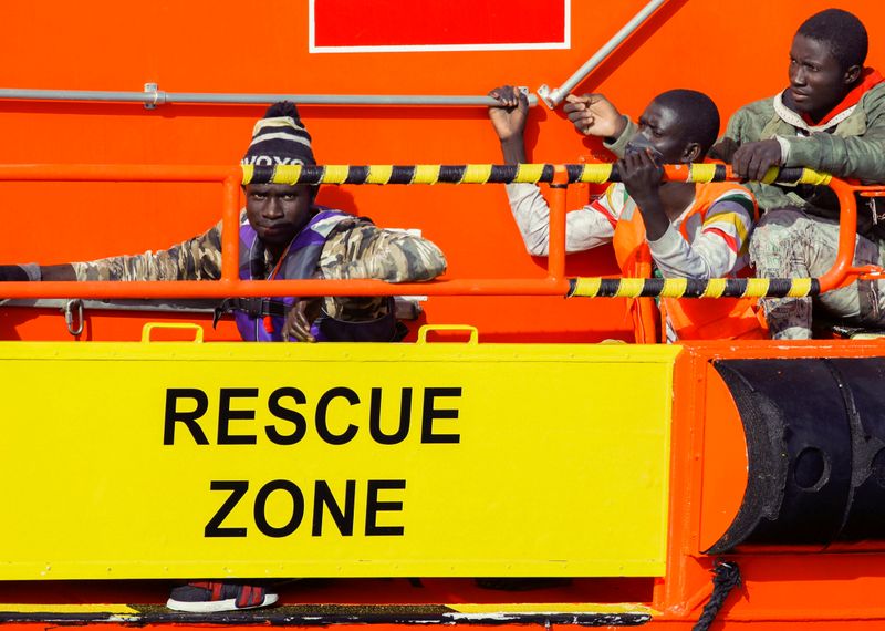 FILE PHOTO: Migrants wait to disembark from a Spanish coast