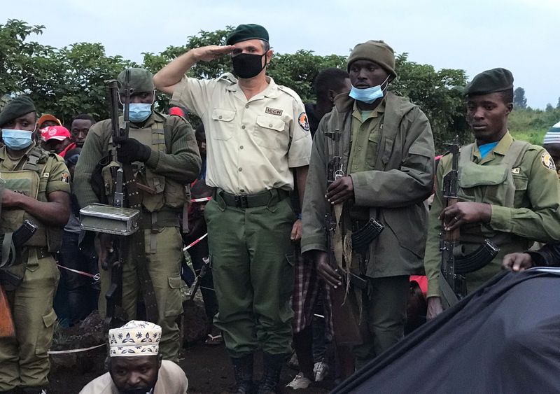 Virunga National Park Rangers and Park director Emmanuel Demerode salutes