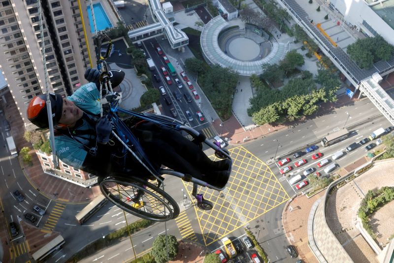 Lai Chi-wai, a paraplegic climber, attempts to climb the 320-metre