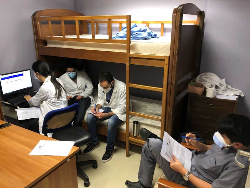 Health workers sit together inside Saint George Hospital University Medical