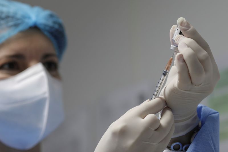 FILE PHOTO: A nurse prepares a dose of the Pfizer-BioNTech