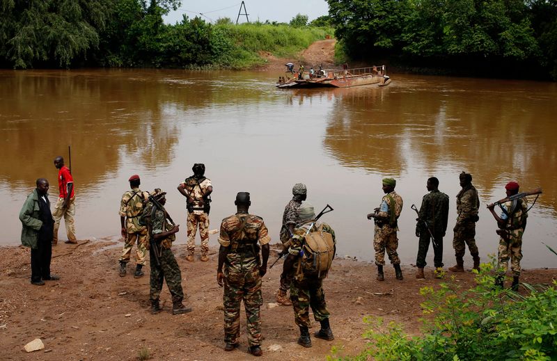 Seleka fighters gathre before crossing a river near town of