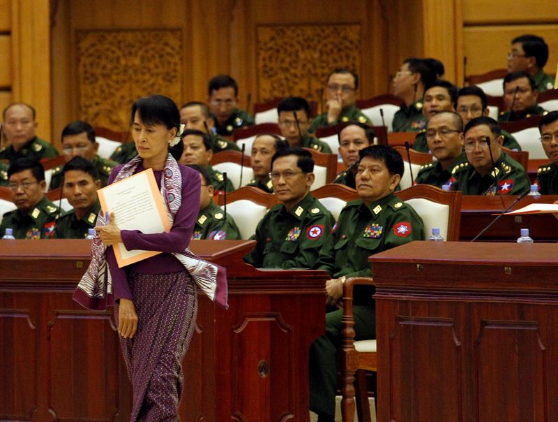FILE PHOTO: Aung San Suu Kyi walks to take an