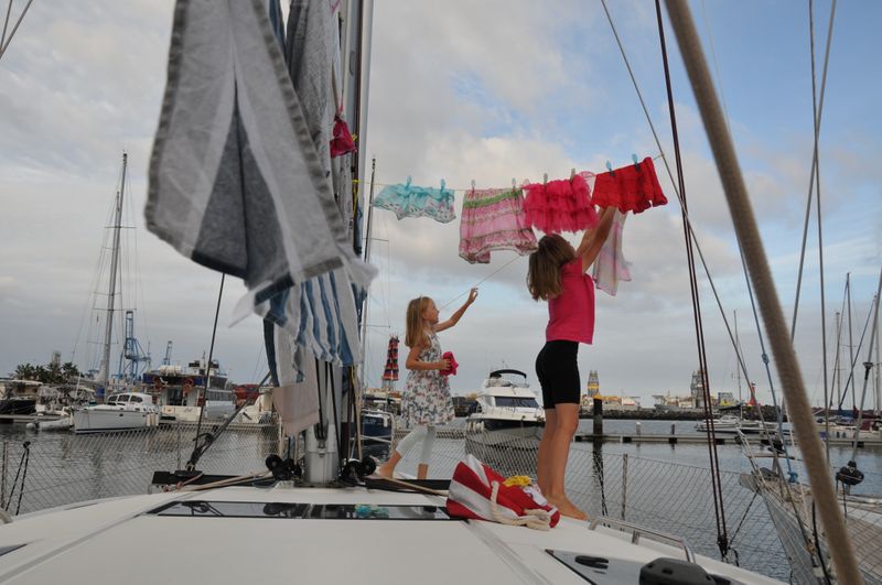 Katalin and Boroka hang clothes to dry on the sailing