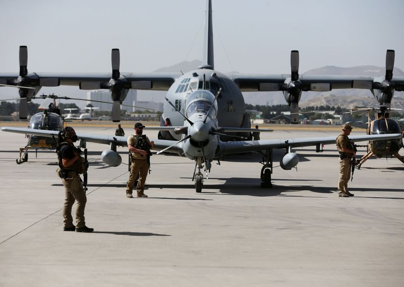 FILE PHOTO: U.S. security personnel stand guard during a handover