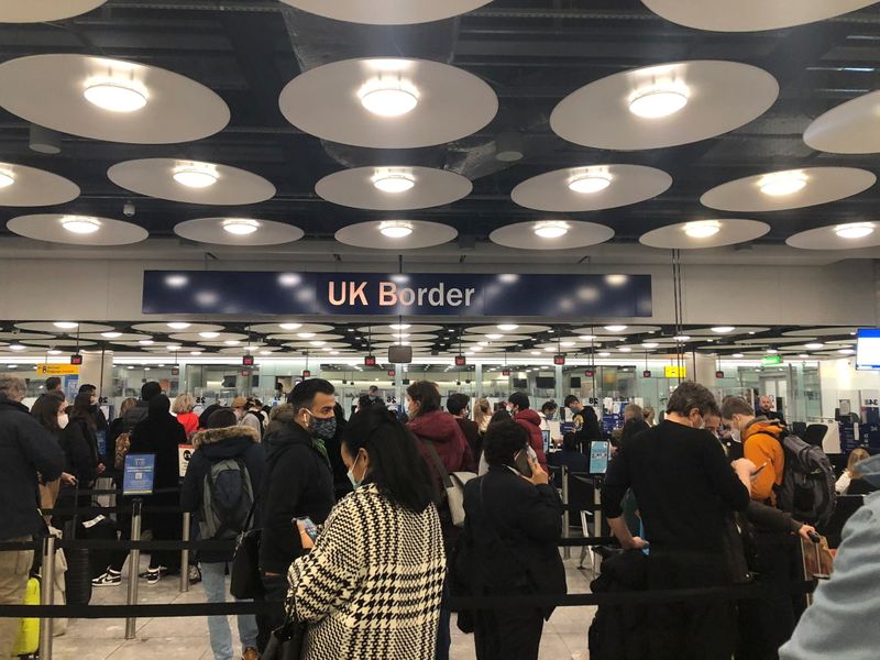 People queue at terminal 5 of Heathrow Airport