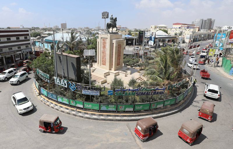 Rickshaw taxis drive past the Ahmed Gurey monument at the