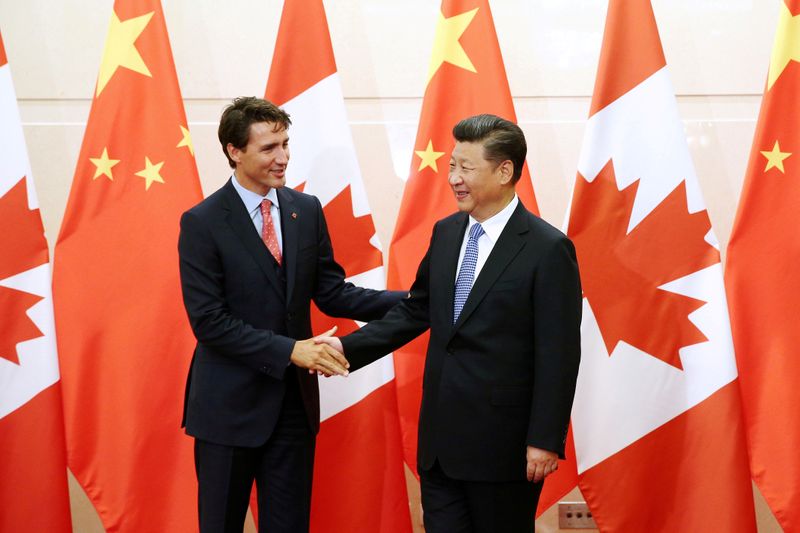 FILE PHOTO: Chinese President Xi Jinping shakes hands with Canadian