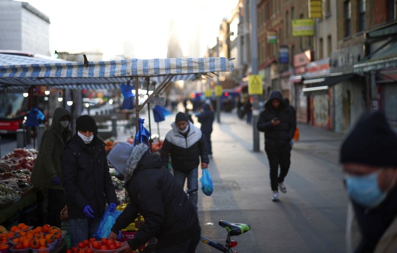 People shop at a market stalls, amid the coronavirus disease