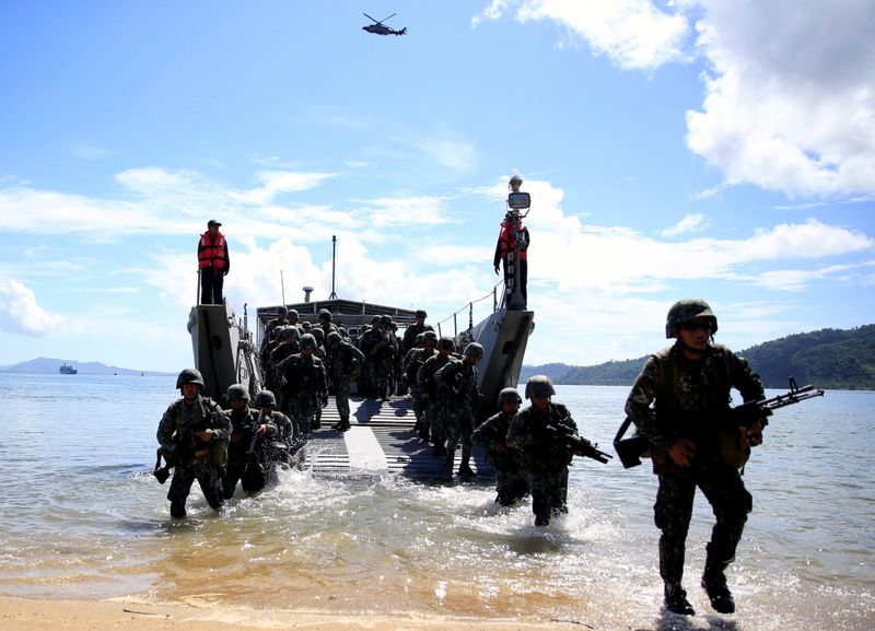 FILE PHOTO: Filipino soldiers disembark from the landing ship before