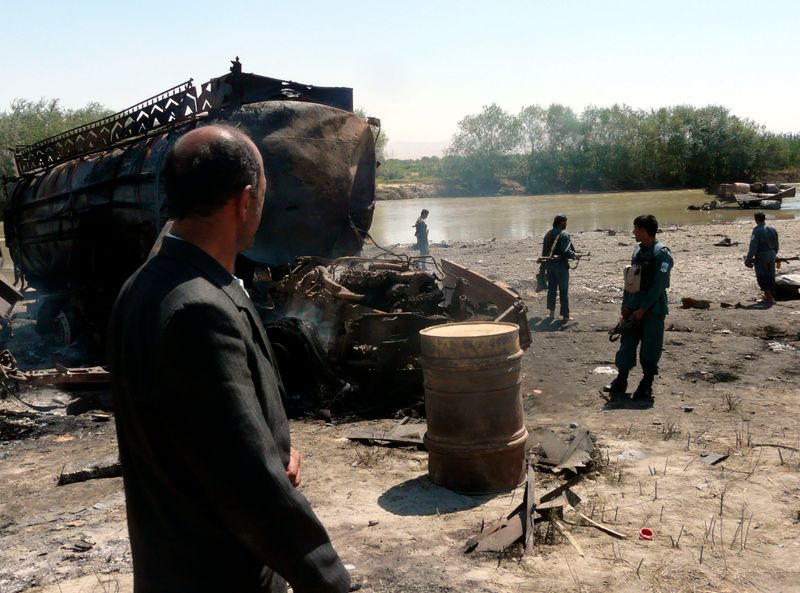 FILE PHOTO: Afghan police inspect the site of an airstrike