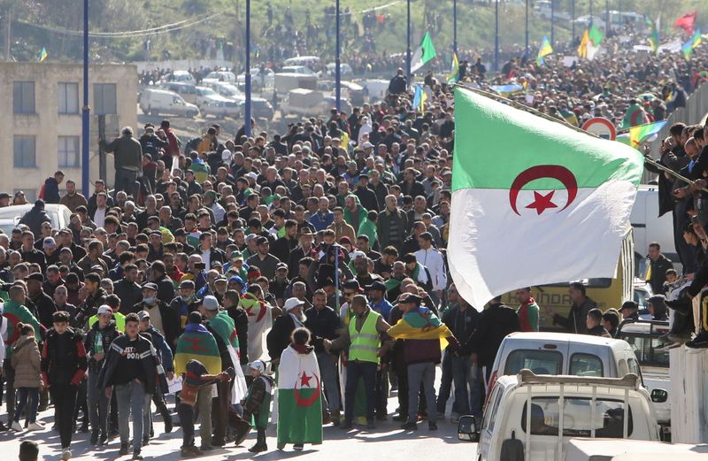 Demonstrators carry national flags as they gather in the town