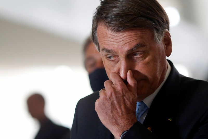FILE PHOTO: Brazil’s President Jair Bolsonaro reacts during a news