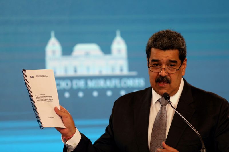 FILE PHOTO: Venezuela’s President Maduro shows a document from the