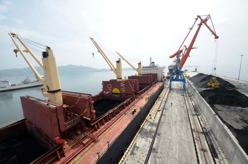 FILE PHOTO: A cargo ship is loaded with coal during