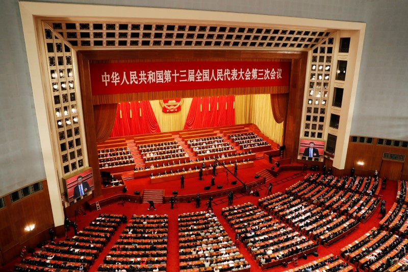 Chinese officials and delegates attend the closing session of NPC