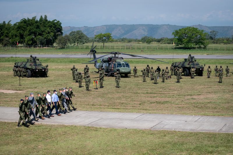 Colombia’s President Ivan Duque marches accompanied by high military commanders,