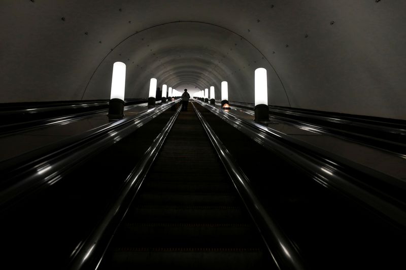 FILE PHOTO: A passenger rides an escalator at a metro