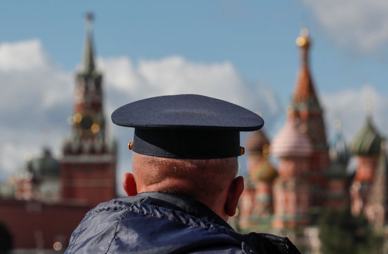 FILE PHOTO: A security guard looks towards the Spasskaya Tower