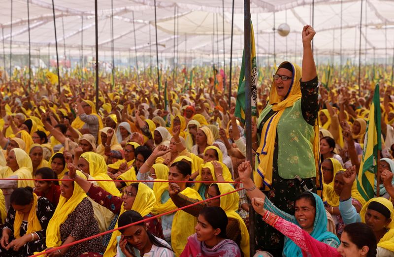 Women farmers attend a protest against farm laws on the