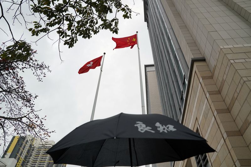 FILE PHOTO: Chinese and Hong Kong flags flutter outside West