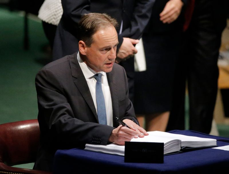 Australian Minister of Environment Greg Hunt signs the Paris Agreement