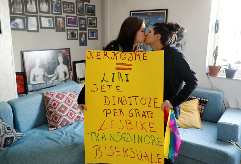 Xheni Karaj, an LGBT rights activist, kisses her girlfriend while