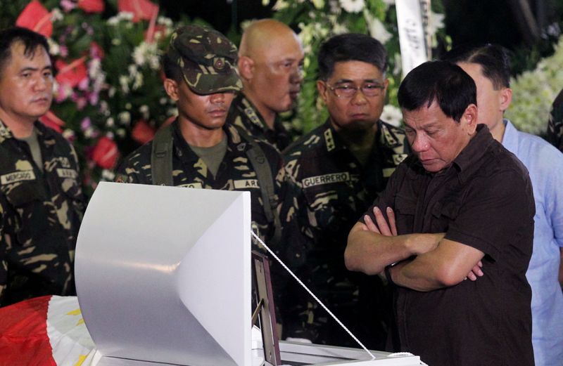 FILE PHOTO: Philippine President Rodrigo Duterte views the body of