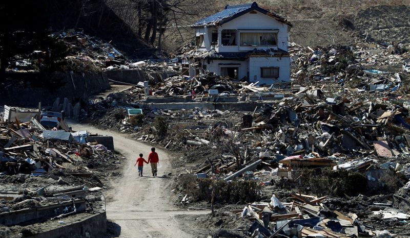FILE PHOTO: People walk at an area that was damaged