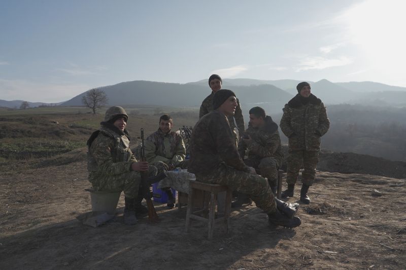 Ethnic Armenian soldiers gather at their fighting positions near divided