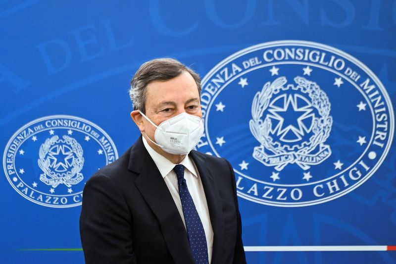 Italy’s Prime Minister Mario Draghi arrives for a news conference
