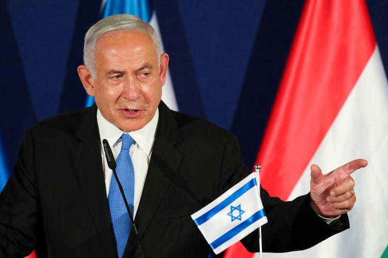 FILE PHOTO: Israeli Prime Minister Netanyahu gestures as he delivers