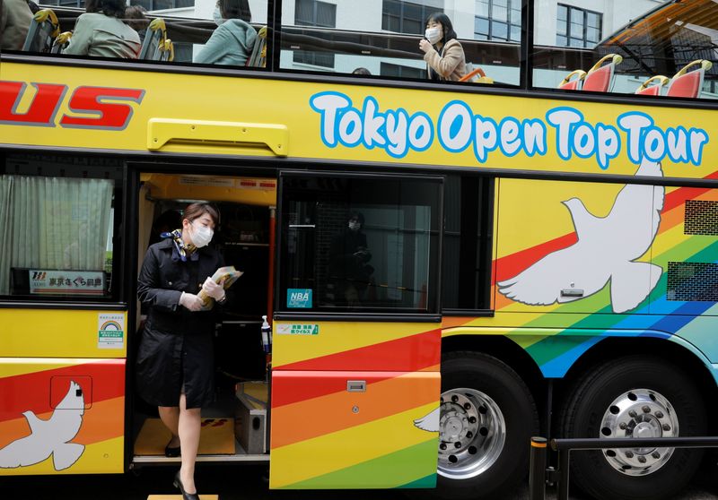 A tour guide of Hato Bus Co. works at an