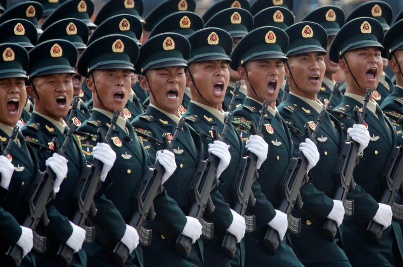Soldiers of People’s Liberation Army (PLA) march in formation past