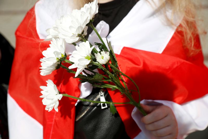 FILE PHOTO: People carrying historical white-red-white flags of Belarus gather