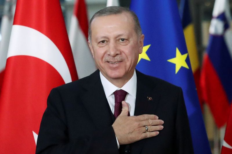 FILE PHOTO: Turkish President Tayyip Erdogan reacts ahead of a