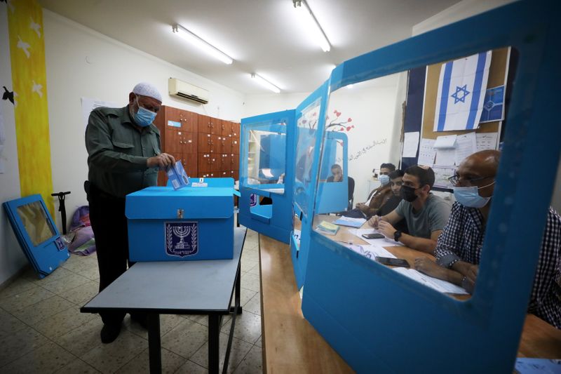 An Arab-Israeli man casts his ballot as he votes in