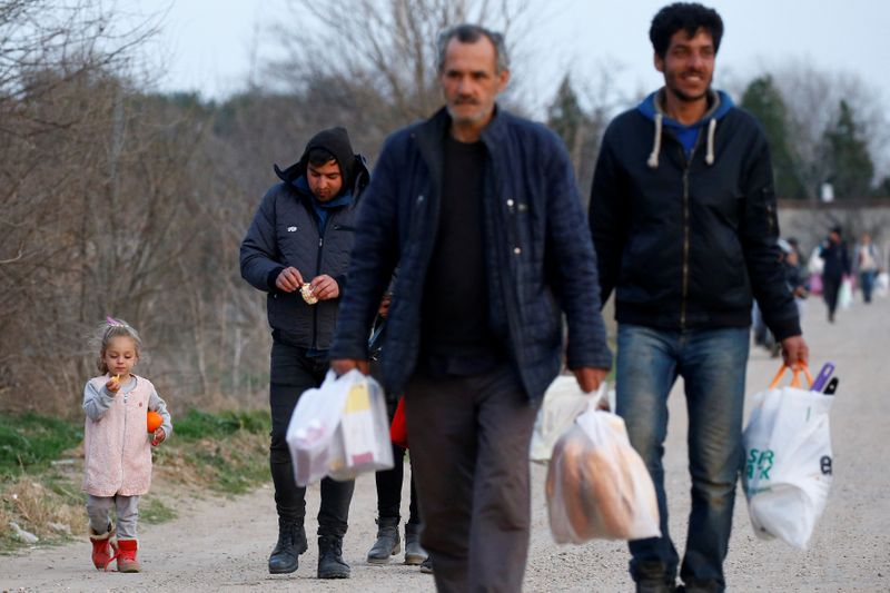 FILE PHOTO: Migrants walk towards Turkey’s Pazarkule in Edirne